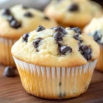 Close-up of moist chocolate chip muffins with golden tops, highlighting their soft texture and delicious appeal.