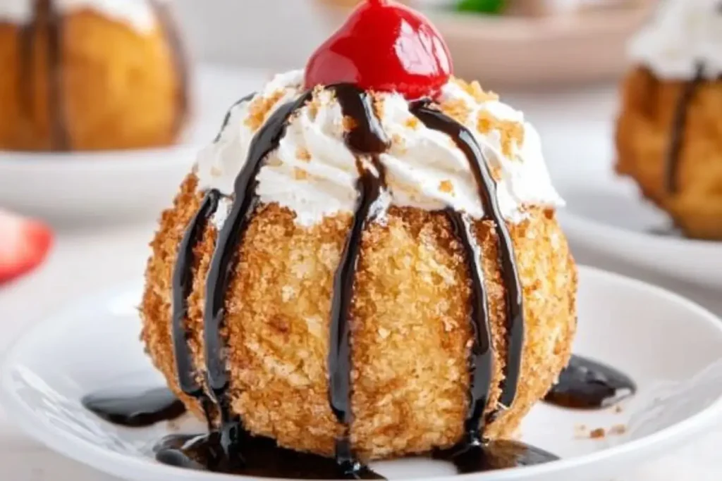 Classic Mexican Fried Ice Cream served with whipped cream, chocolate drizzle, and a cherry on a white plate.